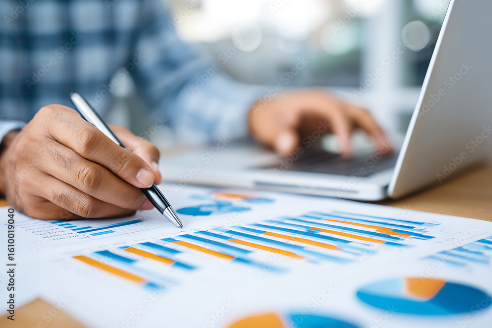 Poster working on data analysis and charts in a modern office environment