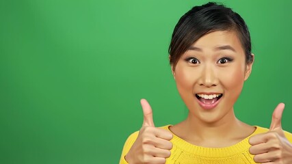 Happy young woman giving thumbs up