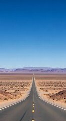 Endless desert highway stretching towards a distant mountain horizon