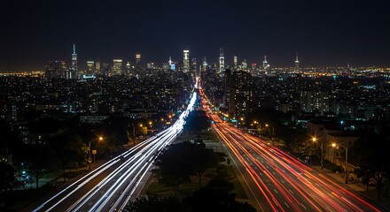 Fototapeta premium Night cityscape: vibrant city skyline with light trails on highway, long exposure photography.