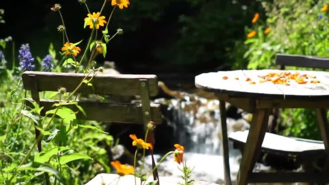Rustic outdoor table by a babbling brook with wildflowers