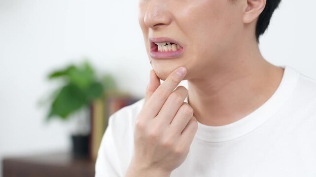 Man suffering from teeth and skin problems