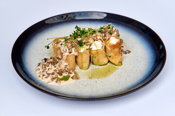 A Gourmet Plate Featuring Delicate Crepes Filled with Soft Cheese and Topped with Fresh Microgreens and a Creamy Sauce