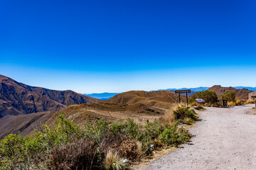 Dirt road leading to a stunning mountain overlook, showcasing the majestic landscape of Salta, Argentina.