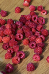 ripe raspberries on a wooden board