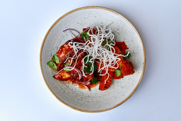 A Colorful Plate of Dish Featuring Various Ingredients Including Vegetables, Herbs, and a Unique...