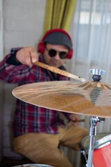musician plays the cymbals on the drum kit