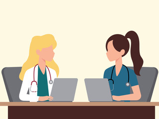 Two female doctors using laptops in the office, discussing diagnosis
