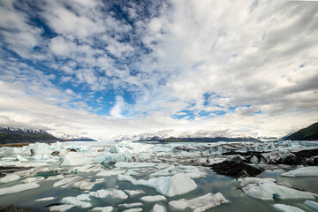 Glacial Lake with Ice Floes and Snowy Mountains