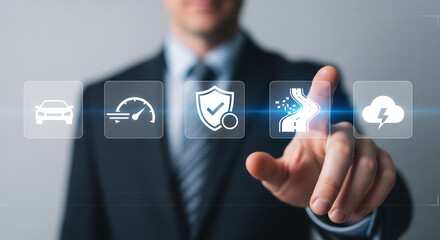 Description: A businessman interacts with a futuristic digital interface featuring icons related to automotive safety and performance, including a car, speedometer, shield, road, and cloud with lightn