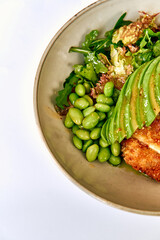 Delicious Bowl Featuring Crispy Chicken, Fresh Greens, Edamame, and Creamy Avocado for a Nutrient-Packed Meal Perfect for Health Enthusiasts