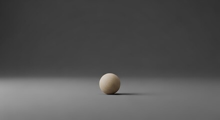 A simple composition of a beige sphere on a minimalist gray gradient background creating a serene