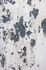 A weathered white painted metal surface shows significant peeling and flaking