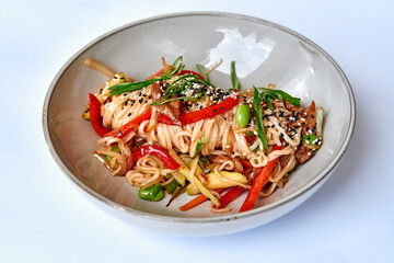 A Colorful Bowl of Stir-Fried Noodles with Vibrant Vegetables, Perfectly Garnished with Sesame...
