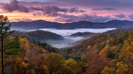 Fototapeta premium Panoramic autumn view of Great Smoky Mountains with colorful foliage on rolling hills, mist over valley, and vibrant sunset sky featuring orange and pink clouds creating a peaceful natural scene.