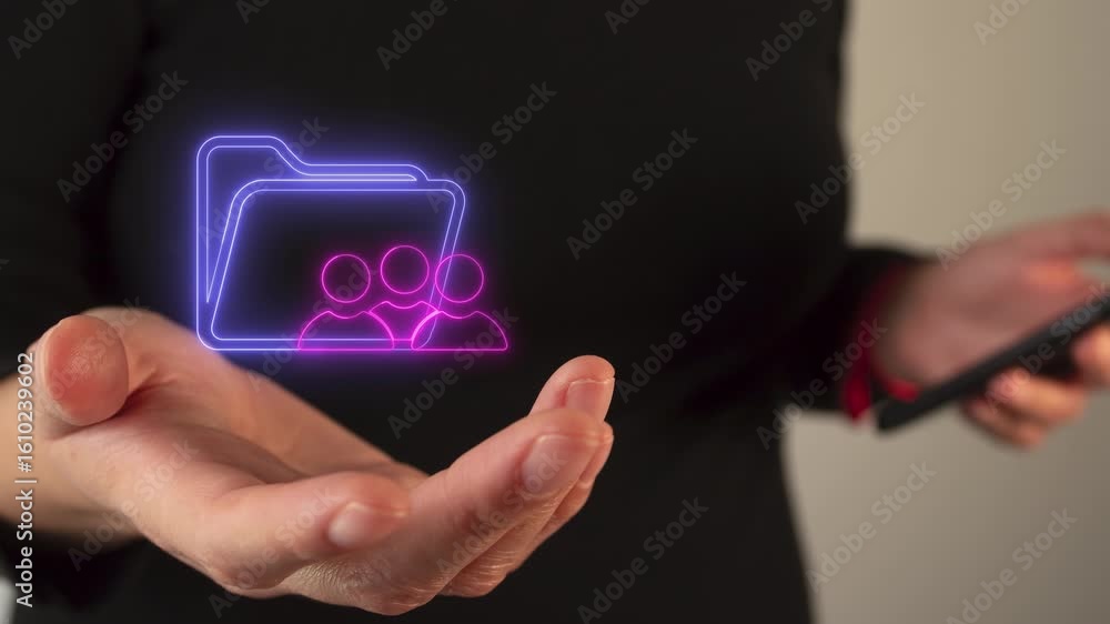 Poster hands of a person holding a virtual, luminous icon of a folder and a group of people