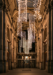 Nighttime luxury shopping gallery adorned with golden lights