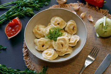 Delicious Homemade Dumplings Plated with Fresh Herbs and Accompaniments, Perfect for a Satisfying...