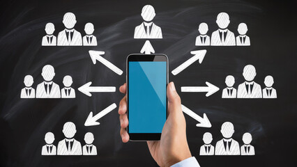Hand holding smartphone connecting diverse teams, illustrating business communication and network growth.