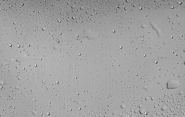 Misty Surface Droplets. A macro shot of water droplets condensed on a light-colored surface. The...