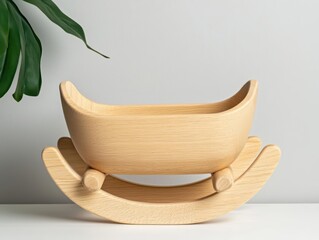 Wooden doll cradle with a cozy curved design, delicate carved details, and a warm handcrafted touch