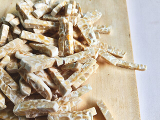 Small Strips of Raw Tempeh on Wooden Board
