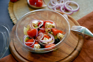 A Fresh and Colorful Salad Featuring Juicy Tomatoes, Crisp Onions, Savory Feta Cheese, and Dark...