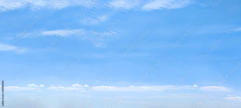 Wall mural clear scene of blue sky and gentle clouds. several wispy white clouds floating in different shapes a
