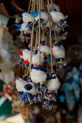 Kash, Turkey, July 10, 2025 - Turkish chickens with beads as amulets against the evil eye hang in a...