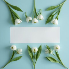 Snowdrop Floral Arrangement with Blank Card Against Blue Background