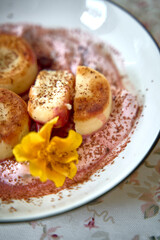 Deliciously Crafted Dessert with Sweet Peaches, Creamy Sauce, and a Floral Garnish Creating a Gourmet Experience on a Delicate Plate