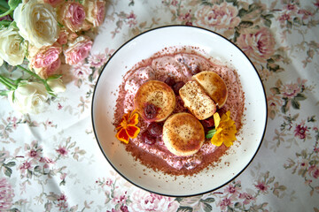 A Tantalizing Dessert Platter Featuring Fluffy Sweet Cakes Nestled in a Delicate Cherry Sauce with...
