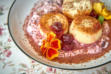 Delicious Dessert Dish Featuring Soft Sweet Rolls with Berry Sauce, Garnished with Fresh Flowers...