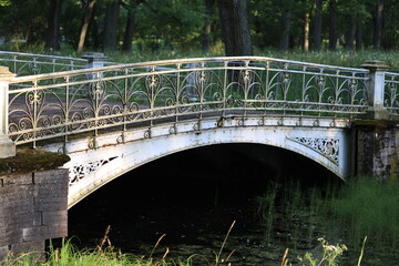 A picturesque scene featuring a bridge spanning a body of water, surrounded by lush greenery