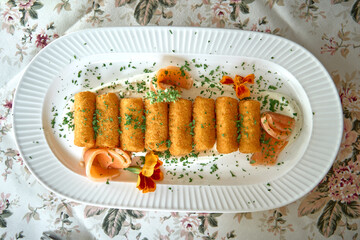A Gourmet Platter of Crispy Croquettes Garnished with Fresh Herbs and Edible Flowers on an Elegant...