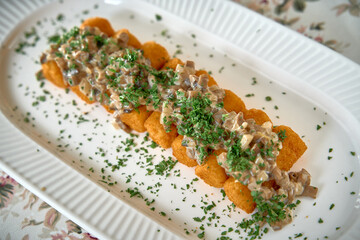 Deliciously Crafted Dish Featuring Golden Fried Croquettes Topped with Rich Mushroom Sauce and...