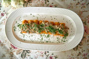 A delectable arrangement of golden crispy fried dough served with a rich creamy topping and fresh...