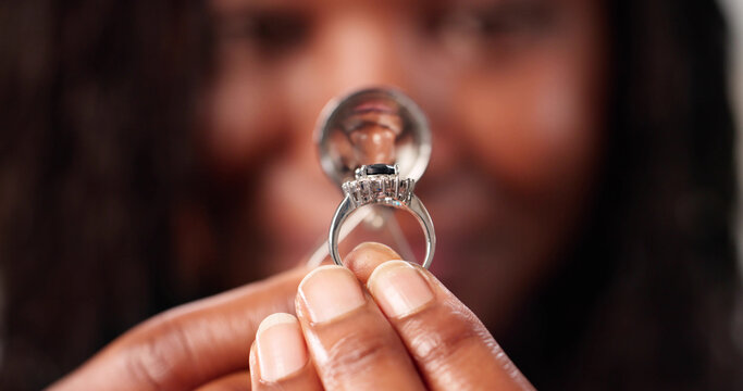 Young Woman Evaluates Diamond Gem With Magnifying Glass