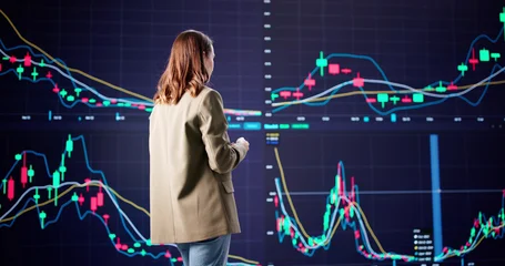  Female Stock Broker Analyzing Market Data © Andrey Popov