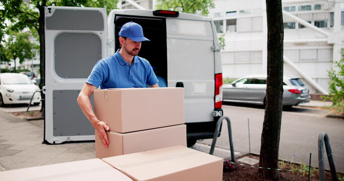 Certified Movers Carefully Loading Furniture Into Commercial Moving