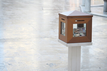 Donation box filled with cash in a public space