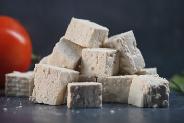 Delicious blocks of tofu with fresh tomato and herbs