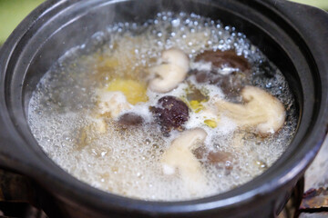 boiling chicken soup with mushrooms and red dates