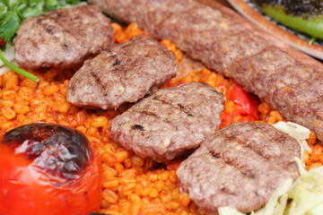 Delicious grilled meat garnished with vegetables and rice
