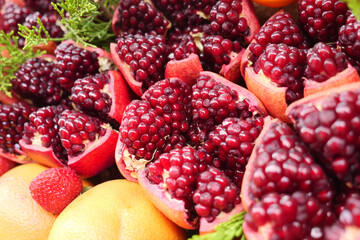 Vibrant display of fresh pomegranates and citrus fruits