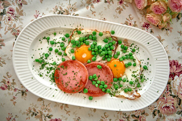 A Deliciously Healthy Breakfast Platter Featuring Eggs, Ham, and Fresh Green Peas Served on a...