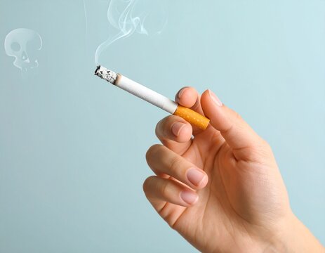 Hand holding a lit cigarette with curling smoke rising upwards - Powered by Adobe