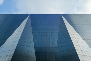 Contemporary Glass Office Building Facade with Geometric Blue and White Panels