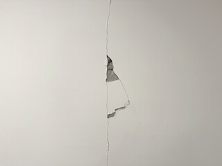 Cement wall crack and break at ceiling to wall from earthquake