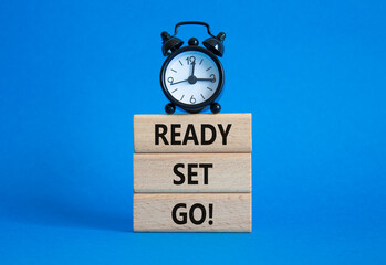 Ready Set Go symbol. Concept words Ready Set Go on wooden blocks. Beautiful blue background with...